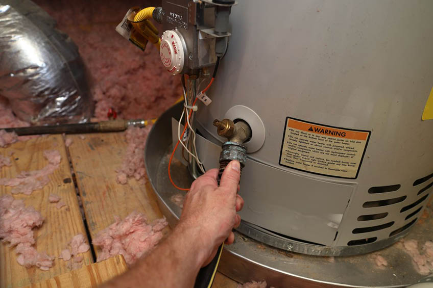 Technician Repairing a Water Heater