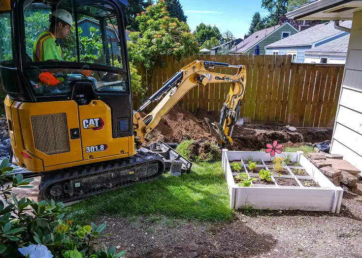 excavator digging up sewer system